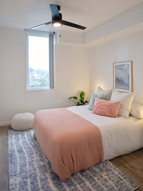 Portland apartment for rent - A bedroom with a bed, a ceiling fan, and a window.
