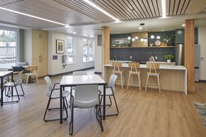 Milwaukie apartment for rent - A modern dining area with a long table and chairs.