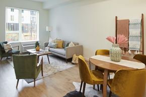 Milwaukie apartment for rent - A living room with a couch, chairs, and a table.
