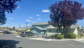 Grandview apartment for rent - A blue building with a green tree in front of it.