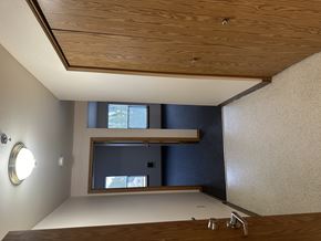 Portland apartment for rent - A bathroom with a wooden ceiling and a round mirror on the wall.