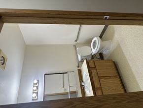 Portland apartment for rent - A view from below looking up at a toilet in a small room.