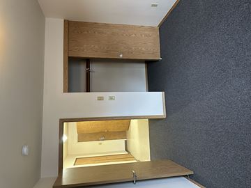 Portland apartment for rent - A modern, minimalist kitchen with a wooden cabinet and a countertop.