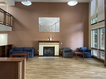 Portland apartment for rent - A living room with a fireplace and a painting on the wall.