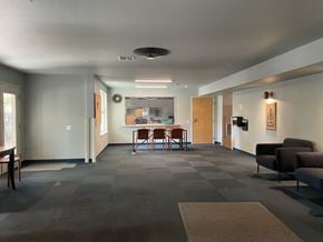 Portland apartment for rent - A grey hallway with a table and chairs in the middle.