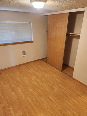 Portland apartment for rent - A room with a wooden floor and a sliding door.