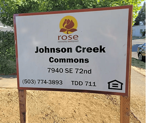 Portland apartment for rent - A sign for Johnson Creek Commons is displayed on a wooden post.