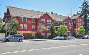 Portland apartment for rent - A red building with a grey van parked in front.