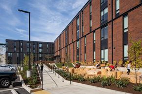 Portland apartment for rent - a large brick building with a playground in front of it