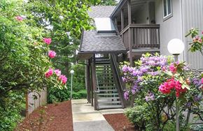 Florence apartment for rent - a house with a porch and a walkway with flowers