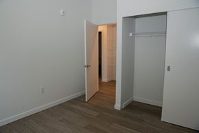 Tigard apartment for rent - a bedroom with a closet and a door into a hallway