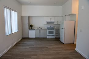 Tigard apartment for rent - an empty kitchen with white appliances and a window