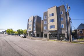 Vancouver apartment for rent - A street view of a residential area with apartment buildings.