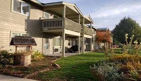 Roslyn apartment for rent - the back of a house with a porch and a lawn