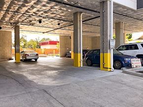 Portland apartment for rent - A parking garage with cars parked in yellow spaces.