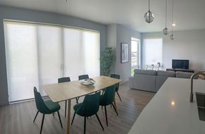 Vancouver apartment for rent - a dining room with a wooden table and green chairs