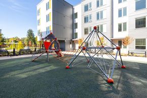 Portland apartment for rent - Playground area with climbing structure and apartments at The Canopy Apartments at Powell, Portland, OR