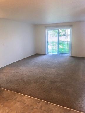 Clackamas apartment for rent - an empty living room with a sliding glass door