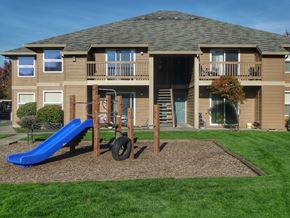 Clackamas apartment for rent - a playground in front of a house with a blue slide