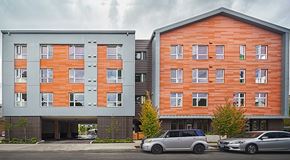 Portland apartment for rent - Two cars are parked in front of a building.