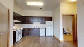 Portland apartment for rent - A kitchen with white appliances and wooden cabinets.