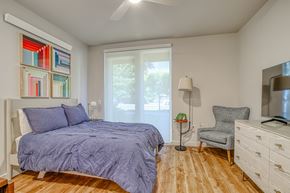 Gresham apartment for rent - A bedroom with a bed, chair, and a painting on the wall.