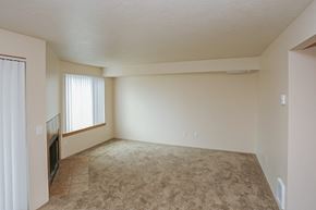 Happy Valley apartment for rent - A living room with a carpeted floor and a window with blinds.