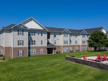 Ellensburg apartment for rent - an apartment building with a yard and a fire pit