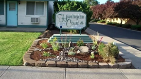 Ellensburg apartment for rent - a landscaped front yard with a sign for the yukon court house
