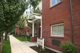 Portland apartment for rent - A white sign is in front of a red brick building.