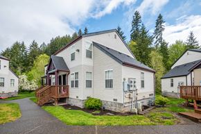 Vernonia apartment for rent - a white house with a porch and a deck on a street