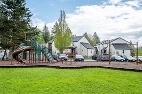 Vernonia apartment for rent - a playground with a slide and a yard with houses