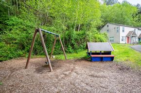 Cannon Beach apartment for rent - a swing set and a picnic table in a backyard