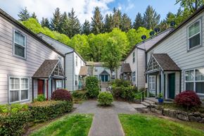 Cannon Beach apartment for rent - a pathway between two houses with a yard and trees