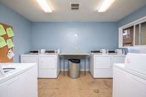 St Helens apartment for rent - a washer and dryer room with laundry machines and a table
