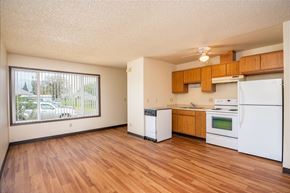 St Helens apartment for rent - an empty kitchen with white appliances and wood floors