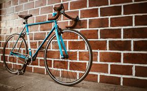 Portland apartment for rent - a blue bike parked against a brick wall