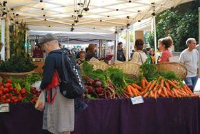 Portland apartment for rent - A man is shopping for vegetables at an outdoor market.