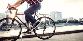 Portland apartment for rent - A person is riding a bicycle on a city street.