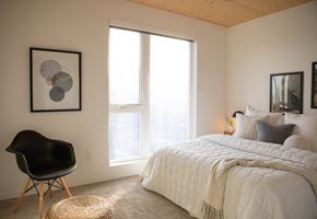 Portland apartment for rent - A bedroom with a large bed and a chair.