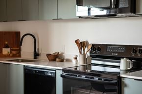Portland apartment for rent - A modern kitchen with a black oven and a black faucet.
