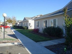 Sunnyside apartment for rent - a white house with a sidewalk in front of it