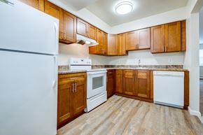 East Windsor apartment for rent - A kitchen with wooden cabinets and a white refrigerator.