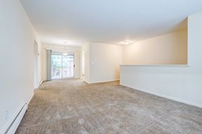 East Windsor apartment for rent - A spacious room with carpeted floor and white walls.