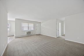 East Windsor apartment for rent - A spacious living room with a fireplace and carpeted floor.