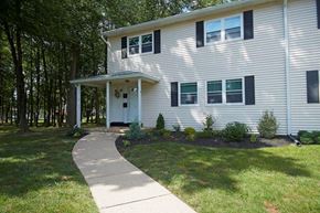 Mercerville apartment for rent - a white house with a sidewalk in front of it