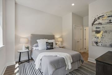 Ewing apartment for rent - A bedroom with a large bed and a painting on the wall.