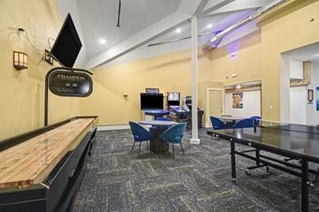 Grandville apartment for rent - A room with a pool table and a sign that says "Champion".