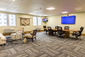 Grandville apartment for rent - a conference room with a tv and a table and chairs
