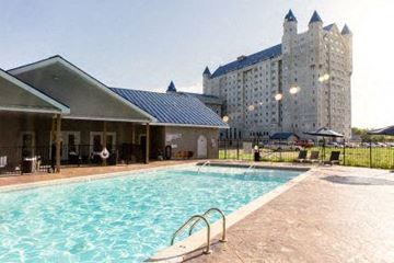 Grandville apartment for rent - a swimming pool with a large building in the background